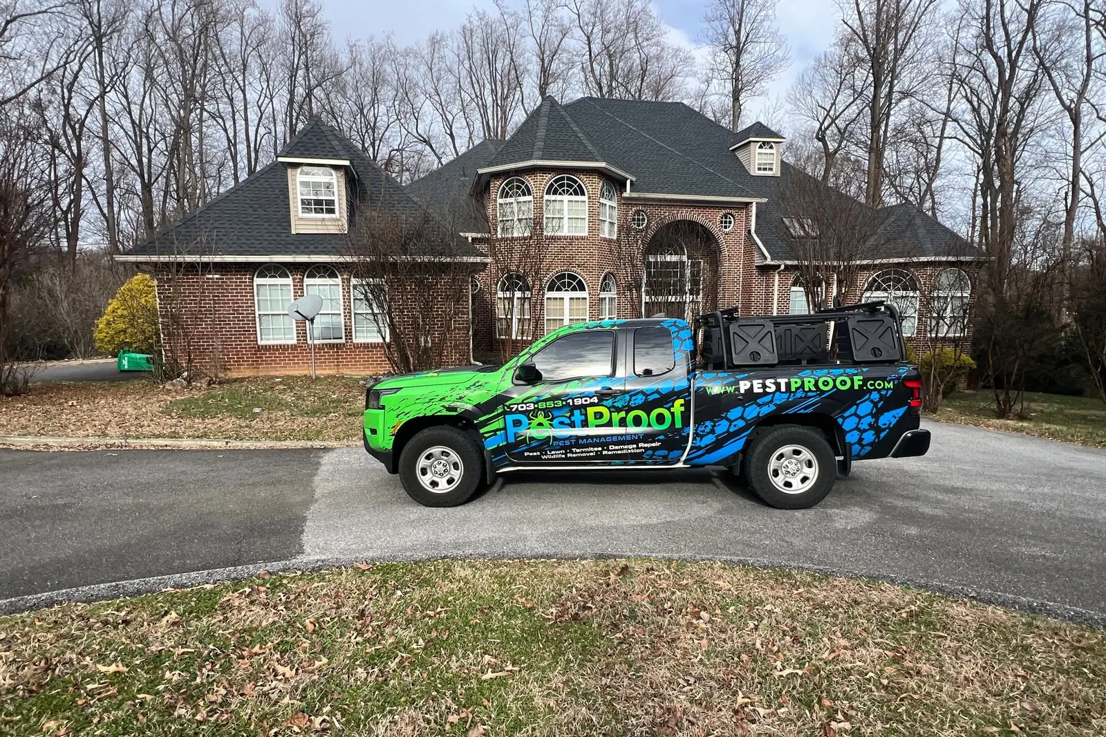Pest Proof technician tied off on a residential roof, installing exclusion at a chimney vent