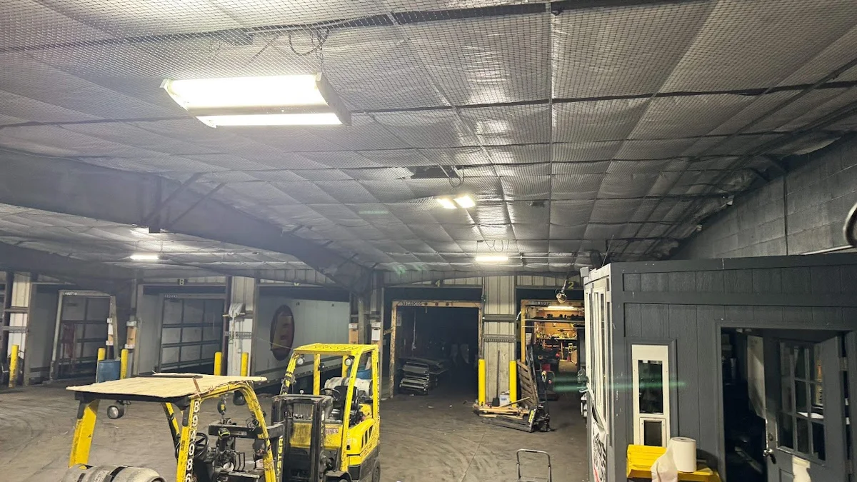 Installed stainless bird-exclusion netting under a porch eave